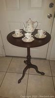 Vintage dark wood foldable side table with Burton tea set arranged on top, showing overall lot contents.