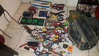 Wide view of assorted hand tools, measuring tapes, scissors, pliers, wrench, tool bags