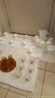 Full lot overview showing milk glass set in back and amber glass and clear Disney glasses in front