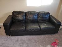 Frontal view of the sofa showing overall condition and cushion alignment