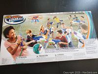 Back of Nerf Super Soaker box showing kids playing with the water guns, emphasizing the set contents and branding.