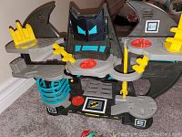 Front and overall view of the Batman Batcave playset showing various platforms and accessory details