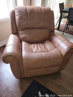 Front view of recliner in upright position showing leather upholstery and rolled arms
