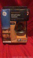Front side of the box showing the GE wired color camera with night vision and home monitoring branding.