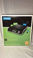 Front view of original DYMO Digital USB Postal Scale box showing product image and 10 lb (4.5 kg) capacity.