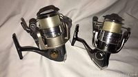 Front angle view of the two Quantum SnapShot fishing reels showing their full structure and spooled fishing lines.