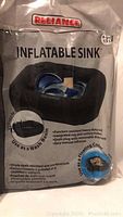 Package front showing Reliance brand inflatable sink with product image and features.