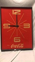 Full view of vintage style Coca Cola wall clock with red background, gold numbers, and black clock hands.