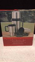 Photo of product box front showing three piece stainless steel vacuum bottle and mug set with red border.