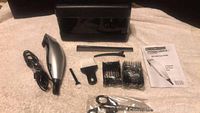 Photo of Remington Precision hair clippers laid out alongside all included accessories on a white surface.