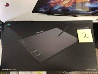 Box front showing Huion 13.8x8.6 inch wireless graphics tablet image and model WH1409 8192 with stylus pen.