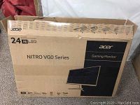 Cardboard box packaging with Acer branding and model details visible