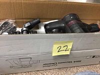 Dibea DT18 vacuum and parts inside open box, side view showing vacuum body and attachments.