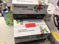 Two boxes of Premium Toner Cartridges model ML1710, stacked with one box opened and one sealed.