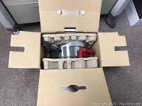 Top view of Big Boss oil-less fryer packed inside cardboard box with protective insert.