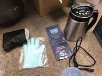 Extractor unit, gloves, pouch, pamphlet and power cord arranged on carpet.