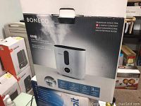 Front of sealed retail box showing brand, model, mist options and Swiss company heritage