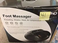 Box showing product name and features including kneading, shiatsu, heat, air compression with icons and product image.