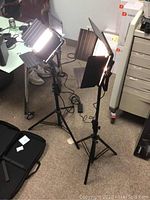 Two GVM LED panel lights on tripods with barn doors illuminated