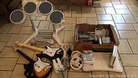 Overview of all items including drum kit, guitars, console, box of accessories