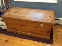 Top view of wooden chest showing surface wear, scratches and wood grain texture.