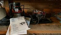 Overview of router table, dustless router, manuals and bit case on shelf
