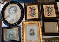 Top view showing all six pieces: antique young girl portrait in round frame, two floral prints in carved mahogany frames, interior scene print in dark mahogany frame, portrait in gold-edged frame, empty frame