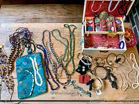 Overall view of spread: necklaces, bracelets, jewelry box and pouches