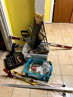 Overview photo showing hand tools including saws, levels, wrenches, screwdrivers in baskets and trays
