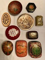 Top view of ten small decorative boxes displaying varied shapes, colors, and patterns