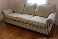 Full front view of the three-seat oatmeal sofa
