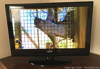 Samsung LCD TV powered on and displaying image.