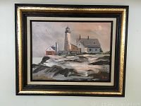 Framed oil painting of Pemaquid Light lighthouse and lightkeepers' house in winter, showing full painting and frame.