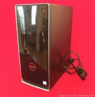 Front and right side view of Dell Inspiron 3668 tower on red background with power cable