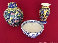 Three Chinese pottery pieces: large tea caddy with floral lid, blue and yellow floral vase, and blue and white decorative bowl