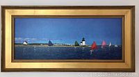 Full view of the large framed canvas print depicting sailboats on water and a lighthouse on shore under blue skies.