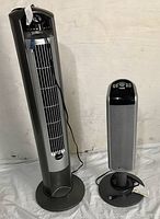 Wide angle photo of both tall and small LASKO tower fans showing overall appearance.
