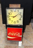 Front view of vintage square light-up clock with illuminated Coca-Cola panel beneath, showing the entire height and design.