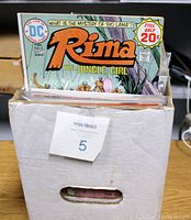 White cardboard box half full of bagged comic books, top issue Rima the Jungle Girl visible