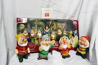 Photo showing PEZ Limited Edition Collector's Series boxed set with Snow White and the Seven Dwarfs dispensers and four vintage plastic dwarf figurines in front.