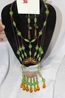 Full view of necklace and earrings set on display bust