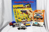 Overview of all items in the lot including the book, Mint On Card Volkswagen Beetle, and four loose Matchbox diecast vehicles