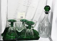 Set showing the clear glass decanter with green stopper and eight cocktail glasses, some glasses placed upside down on the green glass serving tray.