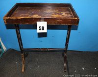 Full view of the antique wooden desk or side table showing tray top and legs.