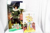 Wizard of Oz Scarecrow Doll in original packaging alongside original movie VHS tape.
