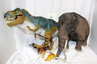Overview of all four prehistoric animal figures showing large T. rex, woolly mammoth, and smaller dinosaur figures
