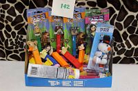Blue PEZ branded table top display box holding 7 new and sealed PEZ candy packages with dispensers featuring various animated and classic cartoon characters.