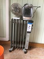 Three items: Holmes radiator heater with fins and wheels, Optimus small heater positioned on top, Windmere fan on the left.