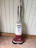 Full upright view of Hoover Shampoo Polisher showing white and maroon plastic body with power cord and handle in standing position.