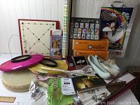 Overall lot showing assorted Korean cultural items including lanterns, footwear, fan, drum, paper items, and games.